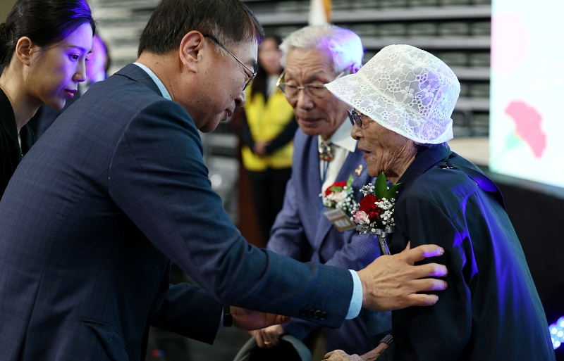 El 8 de mayo, el primer vicealcalde de Asuntos Administrativos del Gobierno Metropolitano de Seúl, Kim Sang-han, regala a Park Ok-rye (dcha.) unos claveles durante la 52ª Celebración del Día de los Padres de Seúl.