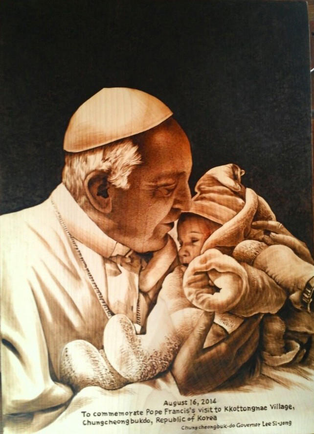충청북도가 음성 꽃동네를 방문한 교황에게 선물한 낙화. 아기를 안고 있는 프란치스코 교황의 모습을 담고 있다. (사진: 충청북도) 