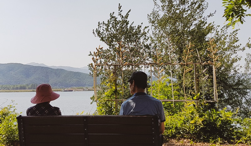 Una pareja mayor compartiendo una banca frente al rio Bukhangang en la ciudad de Chuncheon, el 21 de mayo de 2017.