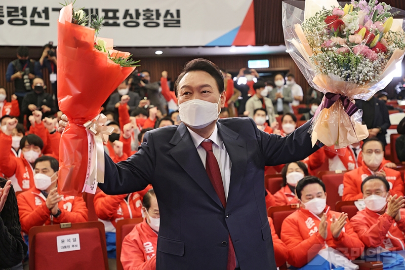 El candidato presidencial del Partido del Poder Popular (PPP), Yoon Seok-yeol, levanta un ramo de flores en la 'Sala de Escrutinio de la 20ª Elección Presidencial del Poder Popular' preparada en la Biblioteca de la Asamblea Nacional en Yeouido, Seúl, cuando se confirmó como ganador de la elección la mañana del 10 de marzo. 