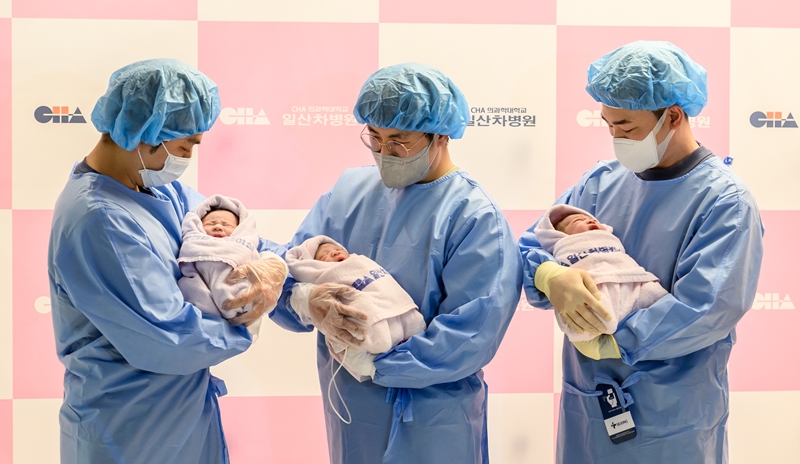 En la imagen, se muestra a unos padres sosteniendo a sus bebés nacidos a la medianoche del 1 de enero, en el Centro Médico Ilsan de la Universidad Cha en Goyang, provincia de Gyeonggi-do. | Centro Médico Ilsan