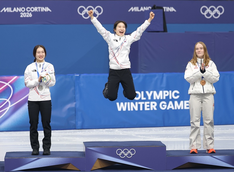 Kim Gil-li (centro) celebra junto a Choi Min-jeong (izquierda) durante la ceremonia de premiación de la prueba de  1.500 metros femeninos de patinaje de velocidad sobre pista corta en los Juegos Olímpicos de Invierno de Milano-Cortina 2026, el 21 de febrero (hora local), en Milán, Italia. | Agencia de Noticias Yonhap