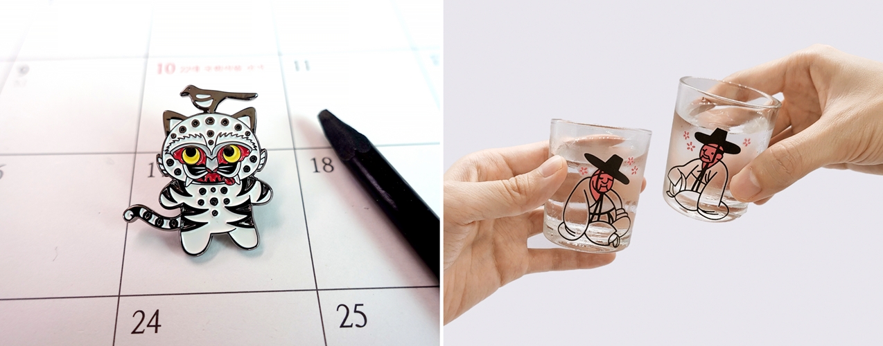 Las fotos muestran el 'pin del tigre y la urraca' (izda.) y el 'set de tazas de los tres eruditos ebrios' que cambian de color, dos de los productos más vendidos de la marca 'MU:DS'.