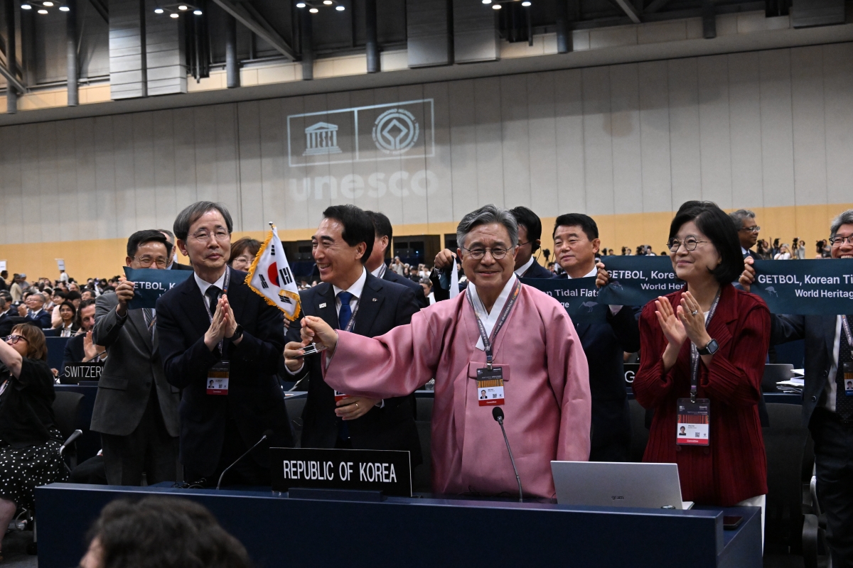 La delegación del Gobierno coreano, que incluye al director del Servicio de Patrimonio de Corea (KHS, por sus siglas en inglés), Huh Min (segundo desde la derecha); y a Kim Ji-hee, embajadora de la Delegación Permanente de Corea ante la Unesco (primera desde la derecha), celebra la ampliación de la segunda fase de los humedales coreanos inscritos como Patrimonio Mundial de la Uesco, el 25 de julio, en el Centro de Exposiciones y Convenciones de Busan (BEXCO). | Servicio de Patrimonio de Corea