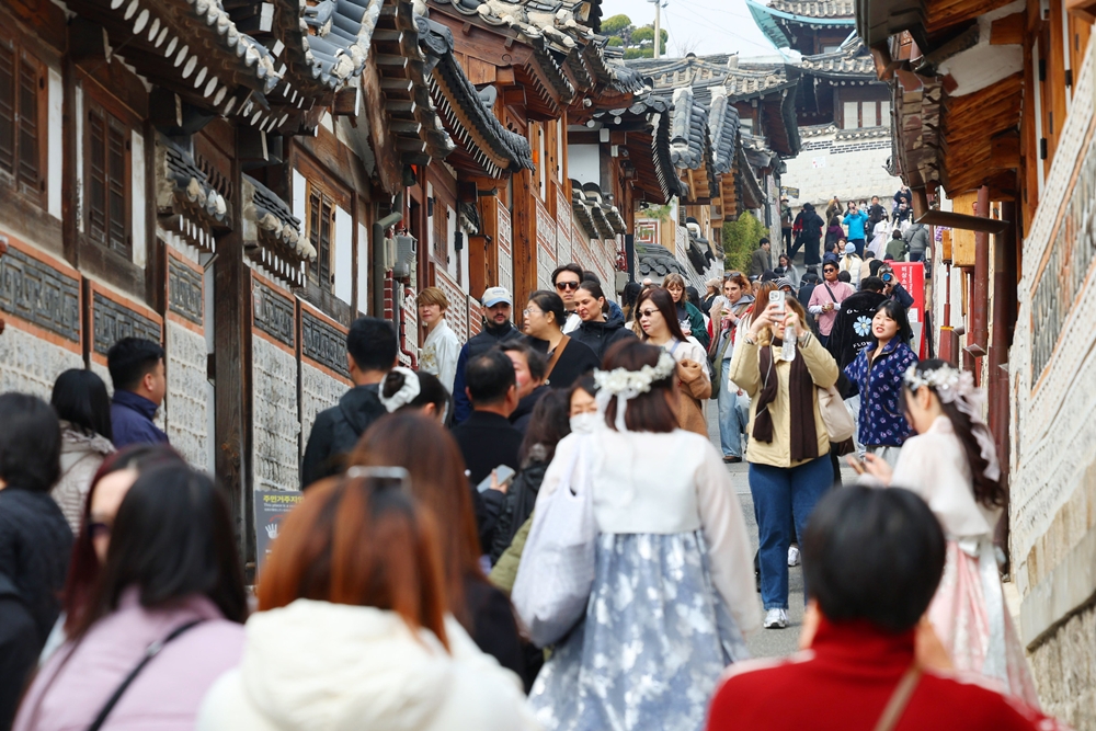 Una multitud de turistas extranjeros recorre, el 16 de marzo, la aldea de casas tradicionales de la aldea Bukchon, situada en el distrito de Jongno-gu, en Seúl. | Korea.net DB style=