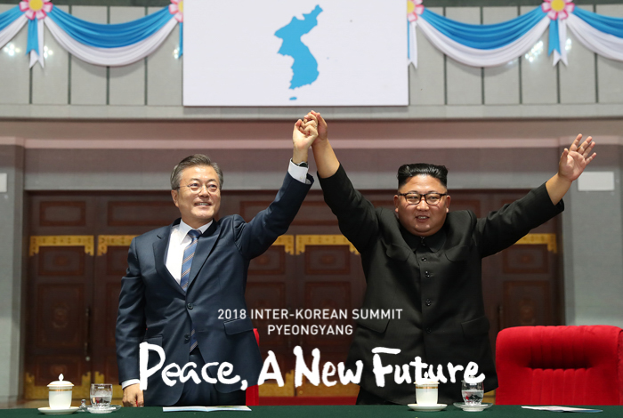 El presidente Moon Jae-in (izda.) y el líder norcoreano Kim Jong Un se juntan para escuchar al público después de ver un espectáculo de gimnasia en el Estadio del Primero de Mayo en Pyeongyang.