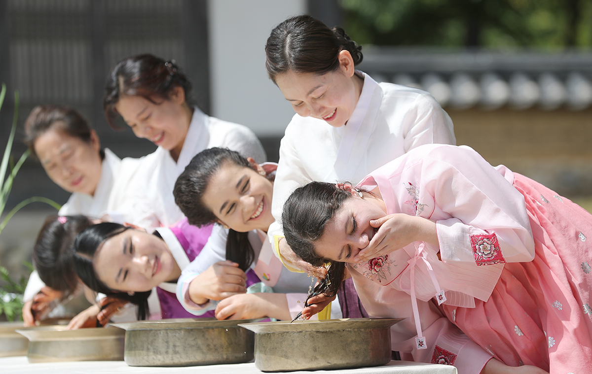 En la ma&ntilde;ana del 20 de junio, dos d&iacute;as antes de la celebraci&oacute;n del Dano (el quinto d&iacute;a del quinto mes lunar), una de las tres principales fiestas tradicionales de Corea, unas estudiantes extranjeras se lavan el cabello con agua mezclada con lirios, en la aldea tradicional coreana de la Universidad de Yeungnam en Gyeongsan, ubicada en la provincia de Gyeongsangbuk-do.El d&iacute;a de la celebraci&oacute;n del Dano, los antepasados coreanos realizaban ritos ancestrales para orar por una rica cosecha y se lavaban el cabello con agua de lirios hervidos, porque cre&iacute;an que esto ahuyentaba a los malos esp&iacute;ritus y hac&iacute;a que el cabello brillara.