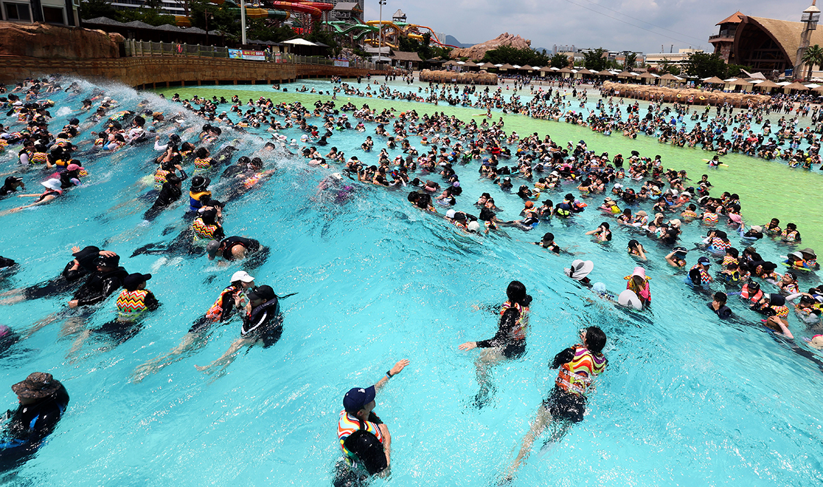 El 1 de agosto, mientras se emitió una alerta por ola de calor en la mayoría de las regiones del país, los visitantes de una piscina al aire libre en la ciudad de Gimhae, en la provincia de Gyeongsangnam-do, disfrutan de las olas artificiales para refrescarse del calor.
