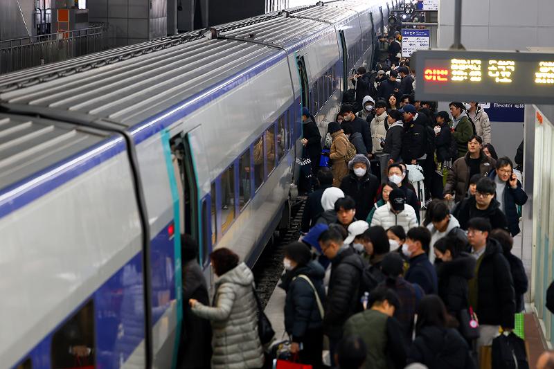 Varias personas suben a un tren en la Estación de Yongsan, en Seúl, el 24 de enero por la mañana, antes de la festividad del Año Nuevo Lunar. 